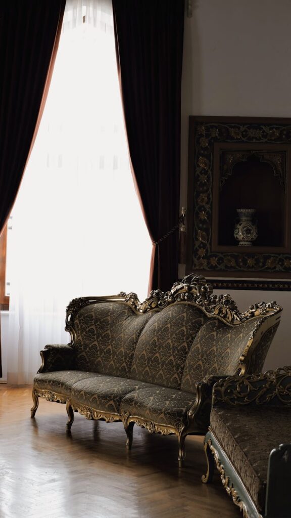 A beautifully ornate vintage sofa with rich upholstery in an elegant living room setting.