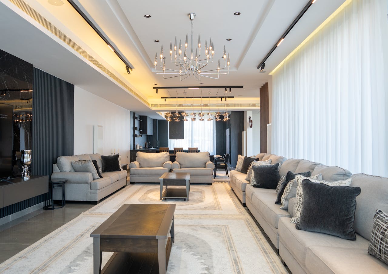 Home Sophisticated and spacious living room featuring modern décor with chandelier.
