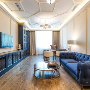 A luxurious apartment interior featuring a blue sofa, modern decor, and elegant lighting.