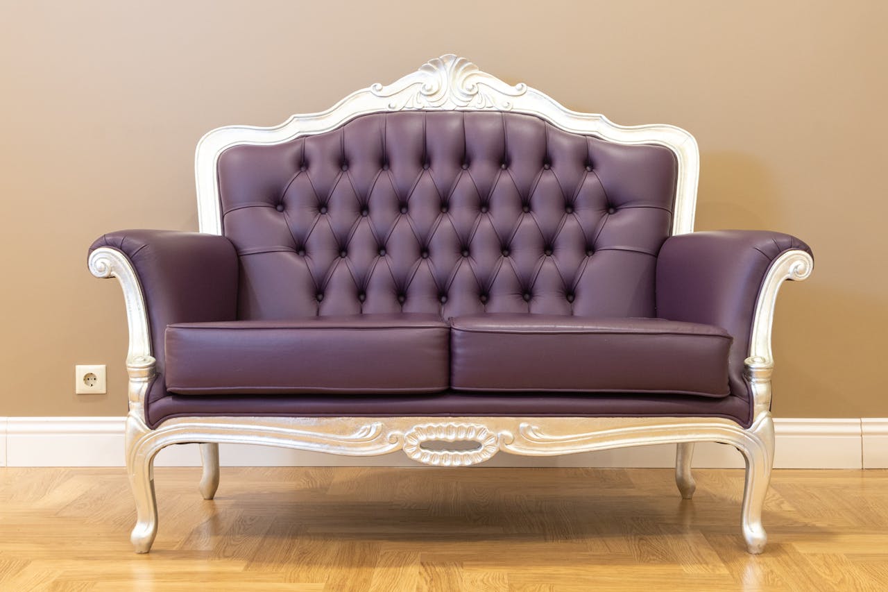 Home Luxurious vintage leather sofa with tufted upholstery and ornate frame, ideal for classic interiors.